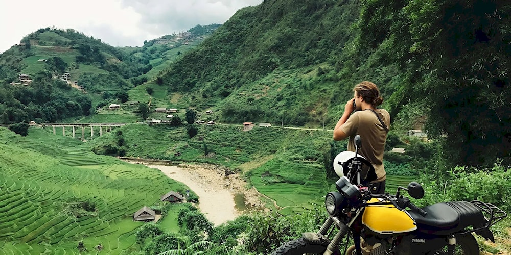 The scenic mountain road journey to Muong Hoa Valley offers stunning countryside views but requires experienced motorcycle riding skills